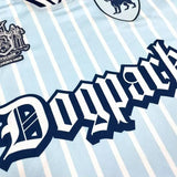 Detailed close-up of custom soccer jersey chest area, showing gothic text and crest logos on striped fabric.