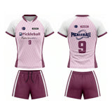 Custom pink and maroon short sleeve V-neck pickleball apparel set with sublimated logo, number 9, and matching shorts.